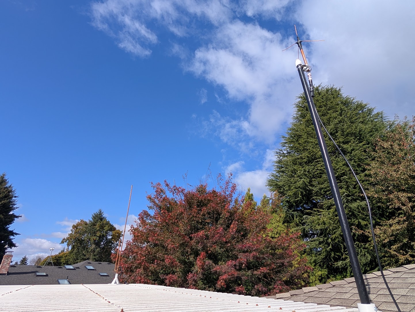 An RHS UHF+GMRS antenna with a DIY copper J pole in the background.