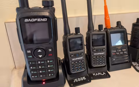 Baofeng UV-28+ next to two UV-5R minis and a Yaesu FT5DR